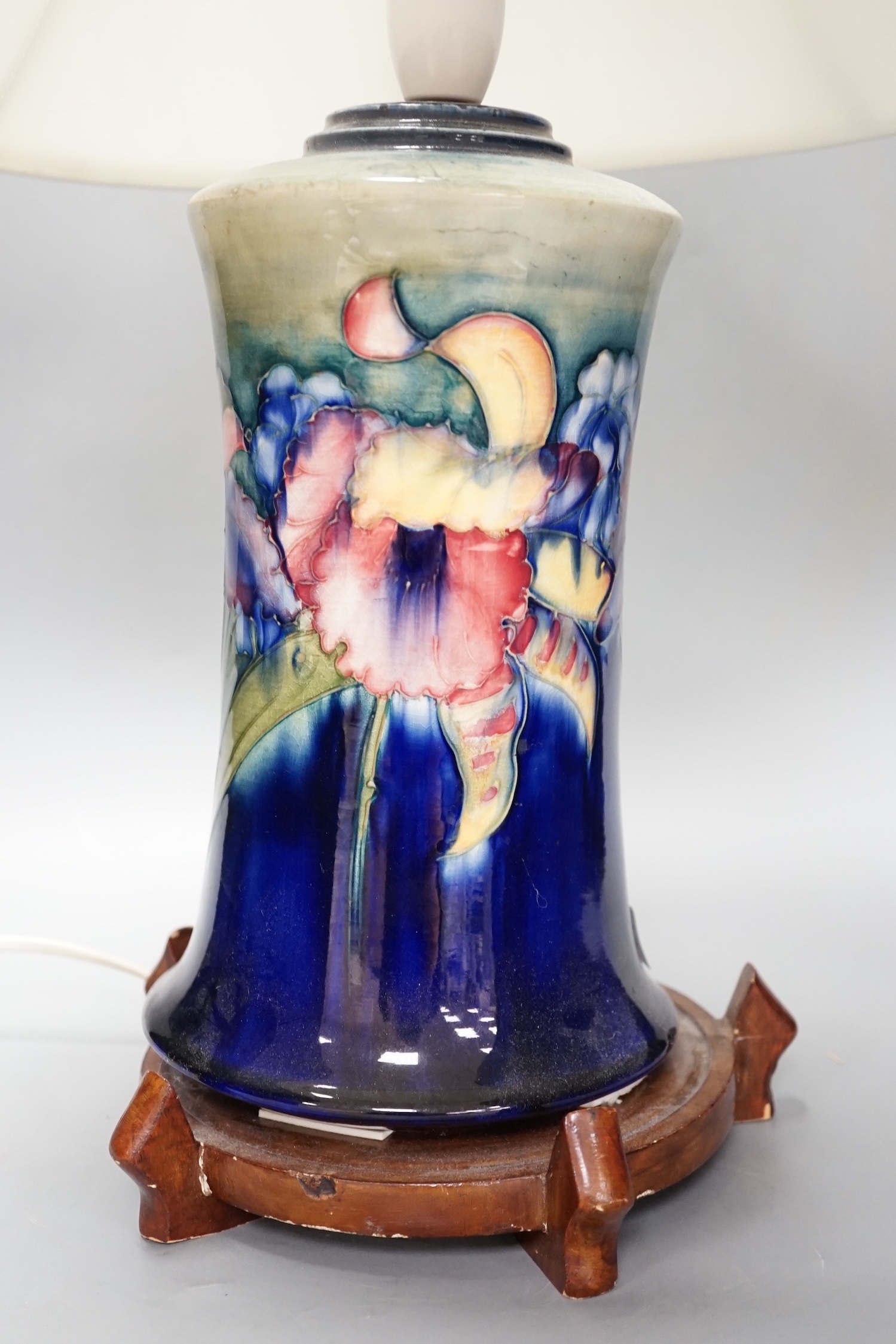 A Moorcroft orchid pattern lamp base with shade and later stand 30cm